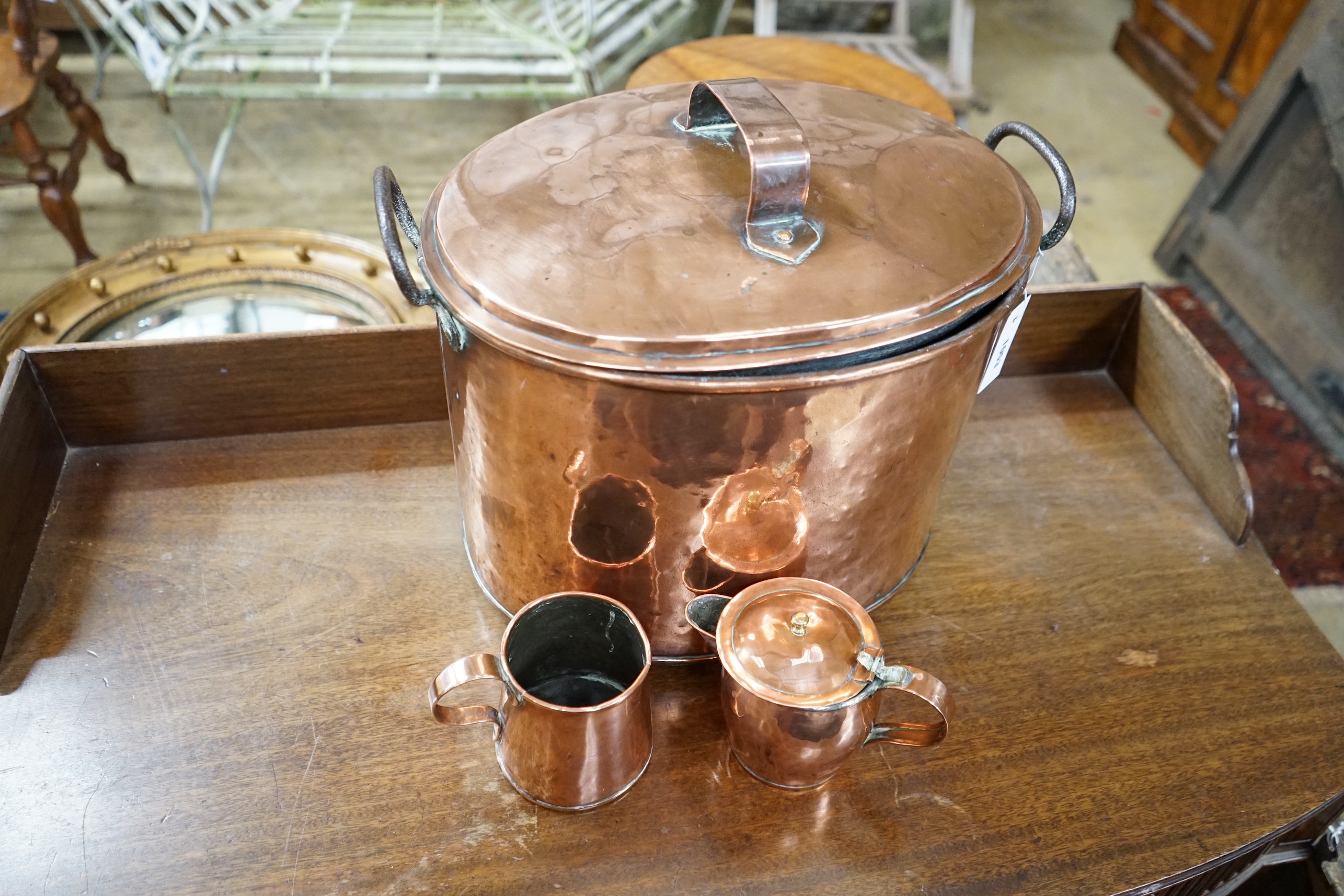 A Victorian oval copper lidded cauldron, height 33cm together with a Victorian copper measure and a jug